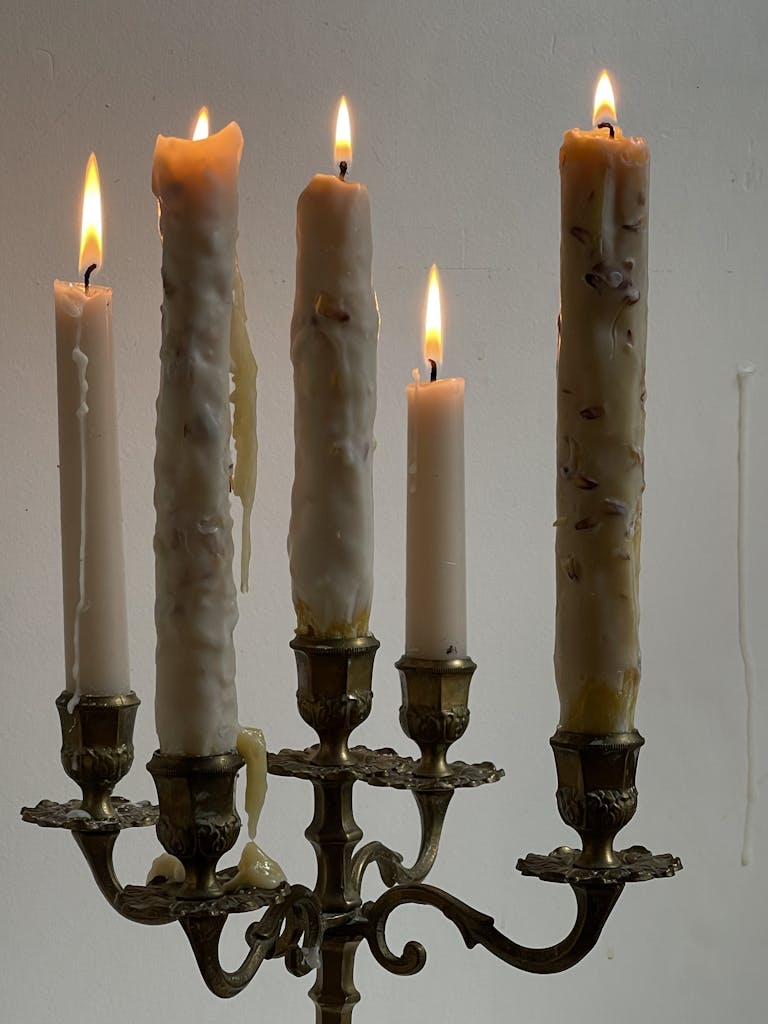 Close-up of vintage candlesticks with burning candles creating a warm and retro ambiance.